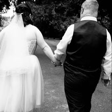 Bride and Groom walking hand in hand.  
